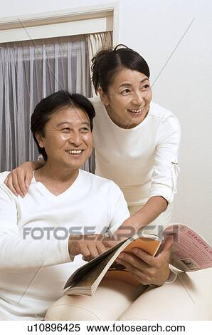 Mature couple reading magazine View Large Photo Image Stock Photography - Mature couple reading magazine. Fotosearch