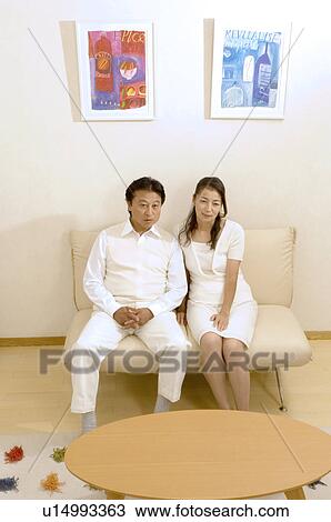 Mature couple sitting on sofa View Large Photo Image Stock Image - Mature couple sitting on sofa. Fotosearch