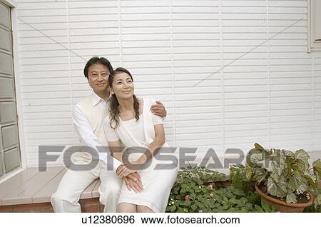 Stock Photograph - Mature couple sitting outside. Fotosearch