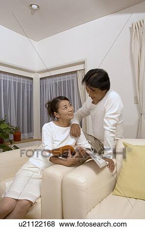Mature couple sitting with magazine View Large Photo Image Stock Photo - Mature couple sitting with magazine. Fotosearch