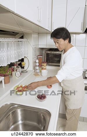 Mature man cooking View Large Photo Image Stock Image - Mature man cooking. Fotosearch