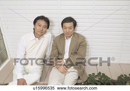 Stock Photography - Mature men sitting outside. Fotosearch