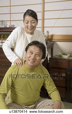 Picture - Mature woman massaging mature man's shoulders. Fotosearch