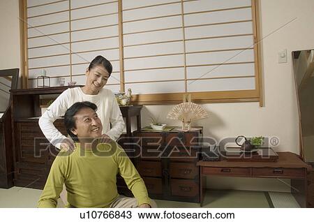 Mature woman massaging mature man's shoulders View Large Photo Image Stock Image - Mature woman massaging mature man's shoulders. Fotosearch
