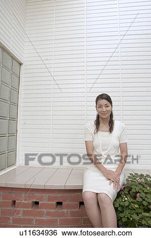 Stock Photograph - Mature woman sitting outside. Fotosearch