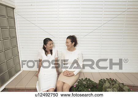 Mature women sitting outside talking View Large Photo Image Stock Image - Mature women sitting outside talking. Fotosearch