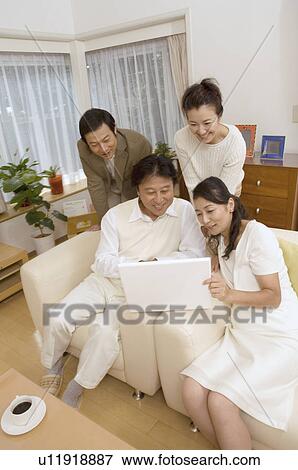 Two mature couples looking at computer screen View Large Photo Image Stock Photo - Two mature couples looking at computer screen. Fotosearch