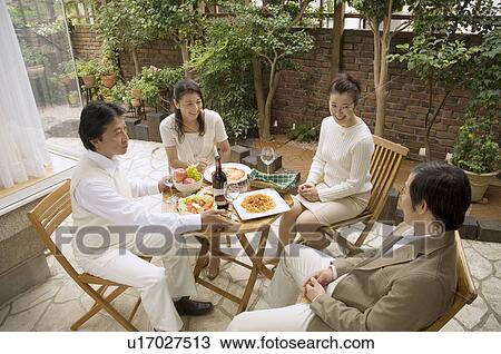 Two mature couples sitting at table outside View Large Photo Image Stock Image - Two mature couples sitting at table outside. Fotosearch