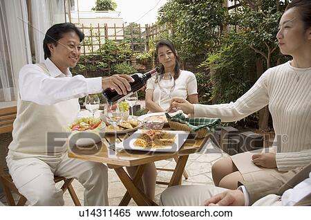 Two mature couples sitting at table outside View Large Photo Image Stock Photography - Two mature couples sitting at table outside. Fotosearch