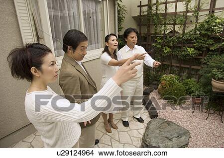 Two mature couples standing outside View Large Photo Image Picture - Two mature couples standing outside. Fotosearch