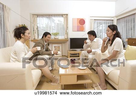 Picture - Two mature couples talking in living room. Fotosearch