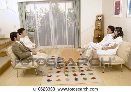 Two mature couples talking in living room View Large Photo Image Stock Image - Two mature couples talking in living room. Fotosearch