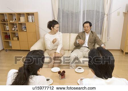 Two mature couples talking in living room View Large Photo Image Stock Image - Two mature couples talking in living room. Fotosearch