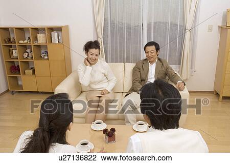 Two mature couples talking in living room View Large Photo Image Stock Image - Two mature couples talking in living room. Fotosearch