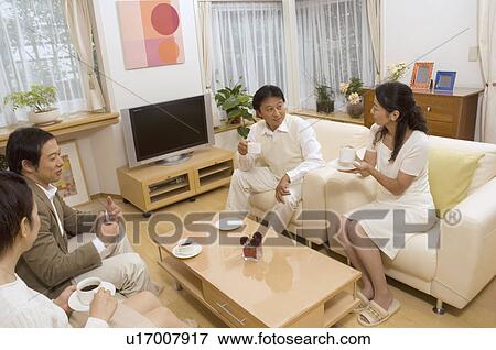 Two mature couples talking in living room View Large Photo Image Stock Photo - Two mature couples talking in living room. Fotosearch