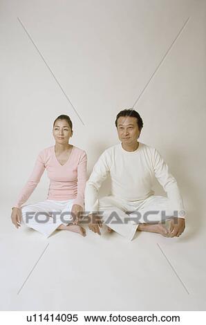 Mature couple sitting cross-legged View Large Photo Image Stock Photography - Mature couple sitting cross-legged. Fotosearch