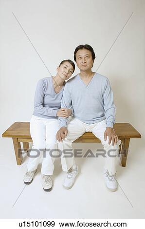 Mature couple sitting on bench View Large Photo Image Stock Photo - Mature couple sitting on bench. Fotosearch