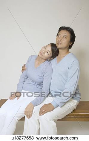 Stock Photo - Mature couple sitting on bench. Fotosearch