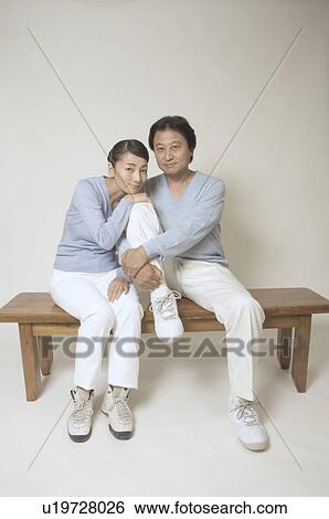 Mature couple sitting on bench View Large Photo Image Stock Photograph - Mature couple sitting on bench. Fotosearch