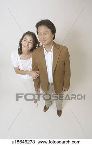 Stock Photo - Mature couple standing arm in arm. Fotosearch