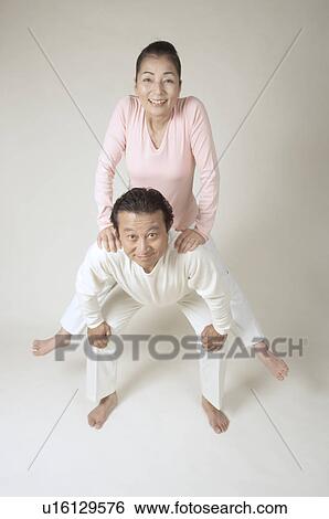 Mature man giving mature woman piggyback View Large Photo Image Stock Photograph - Mature man giving mature woman piggyback. Fotosearch