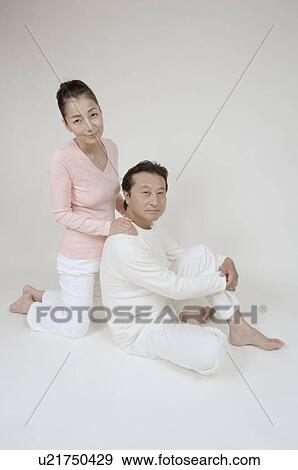 Mature man sitting, mature woman kneeling behind him View Large Photo Image Stock Photo - Mature man sitting, mature woman kneeling behind him. Fotosearch
