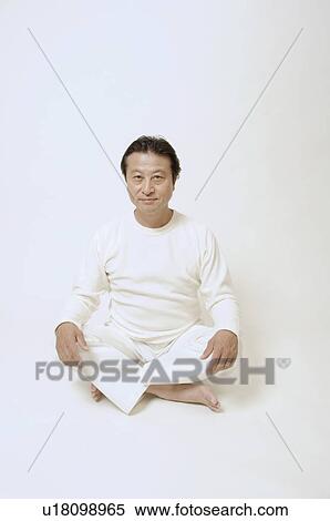Stock Photography - Mature man sitting on floor . Fotosearch