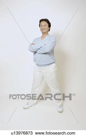 Mature man standing with his arms crossed View Large Photo Image Stock Image - Mature man standing with his arms crossed. Fotosearch