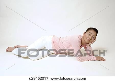 Stock Photo - Mature woman lying on floor. Fotosearch