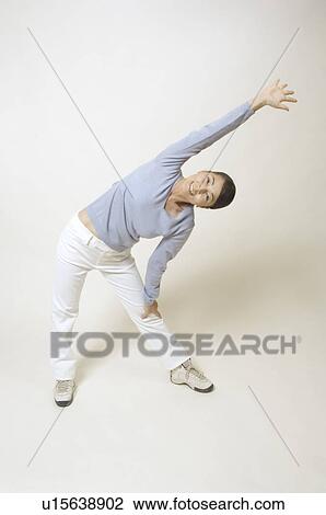Stock Image - Mature woman stretching. Fotosearch