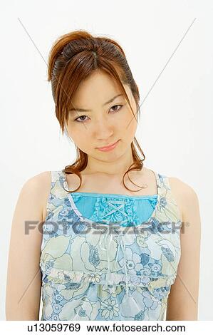 Stock Photo - Young woman frowning. Fotosearch