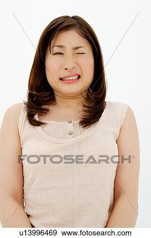 Young woman grimacing View Large Photo Image Stock Photo - Young woman grimacing. Fotosearch