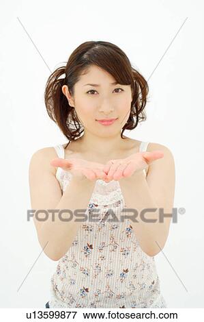 Young woman holding hands out View Large Photo Image Stock Photo - Young woman holding hands out. Fotosearch
