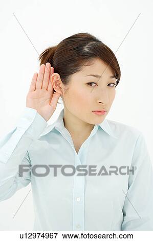 Young woman listening, hand behind ear View Large Photo Image Stock Photo - Young woman listening, hand behind ear. Fotosearch