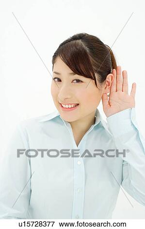 Young woman listening, hand behind ear View Large Photo Image Stock Photo - Young woman listening, hand behind ear. Fotosearch