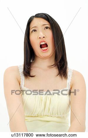 Stock Image - Young woman looking annoyed. Fotosearch