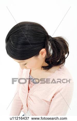 Stock Photo - Young woman looking down. Fotosearch