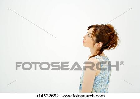 Young woman looking up View Large Photo Image Stock Image - Young woman looking up. Fotosearch