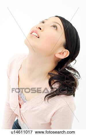Stock Photo - Young woman looking up. Fotosearch