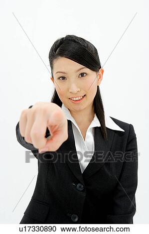 Young woman pointing straight ahead View Large Photo Image Stock Image - Young woman pointing straight ahead. Fotosearch