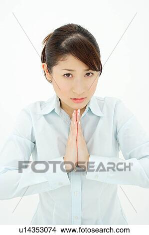 Picture - Young woman praying. Fotosearch