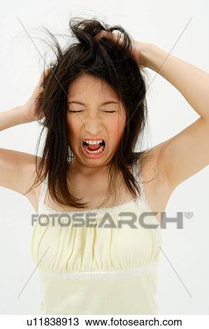 Stock Image - Young woman scratching her head. Fotosearch