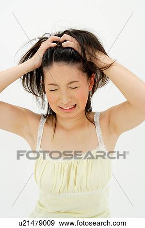 Stock Photo - Young woman scratching her head. Fotosearch