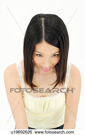 Stock Photograph - Young woman sticking out her tongue. Fotosearch