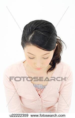 Stock Photo - Young woman with eyes closed. Fotosearch