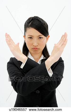 Stock Photo - Young woman with her arms crossed in front of her. Fotosearch