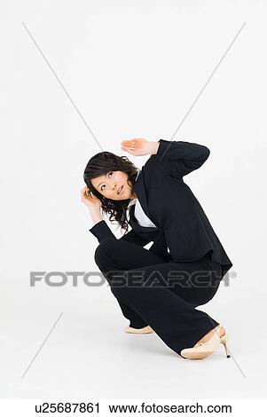Stock Image - Young woman ducking. Fotosearch