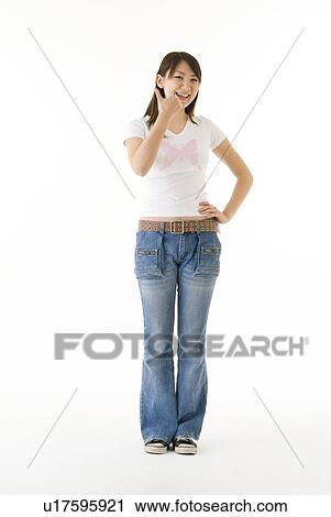 Stock Image - Young woman giving thumbs up. Fotosearch