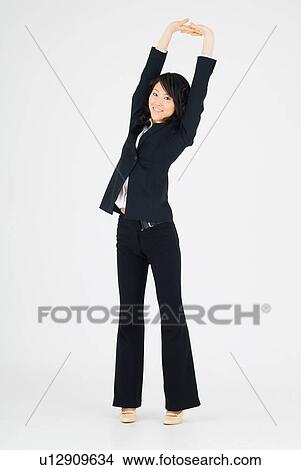 Picture - Young woman holding hands above head. Fotosearch