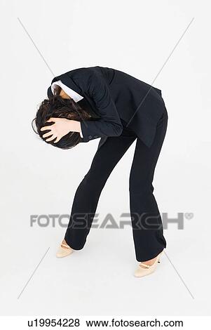 Stock Photo - Young woman holding her head. Fotosearch